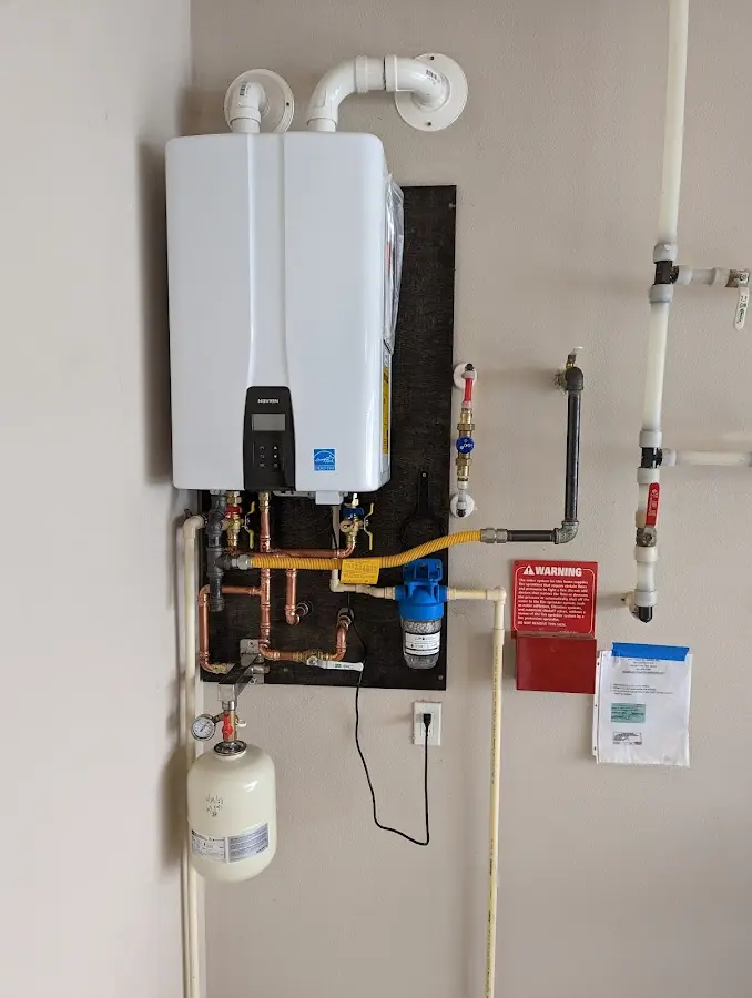 Professional plumber installing copper piping in a Eden Isle home